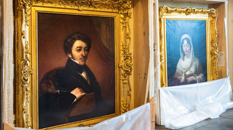 The pair of conserved portraits are unwrapped at Oxburgh Estate